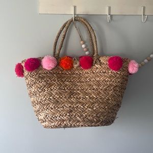 Woven pom pom beach tote